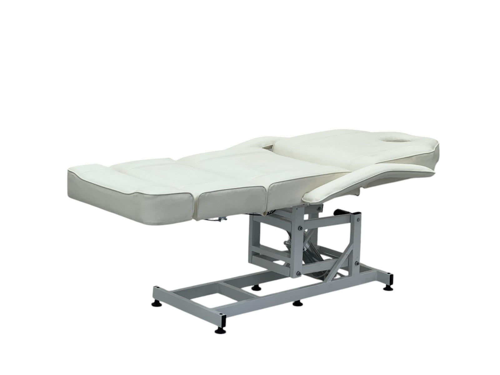 The Karma Taupo is a professional white hydraulic beauty bed featuring adjustable Trendelenburg tilt and antimicrobial vinyl.
