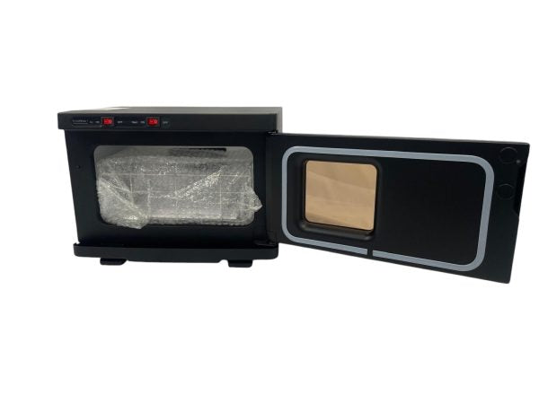 The Karma 8L UV Hot Towel Cabinet in professional gloss black, featuring independent UV and heat power switches, an viewing window, and a compact clinical benchtop frame.