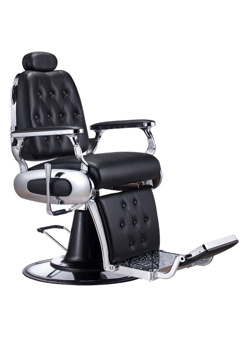 The Karma Airlie Beach Barber Chair is a classic black reclining chair with a heavy-duty hydraulic base, tufted upholstery, and an adjustable headrest.