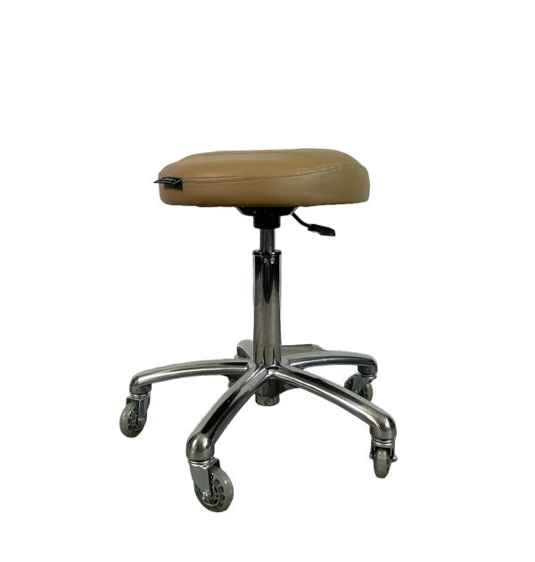 The Karma Burnie is a professional ergonomic salon stool featuring a raised-centre round seat, polished aluminium base, and hair-free rollerblade wheels.
