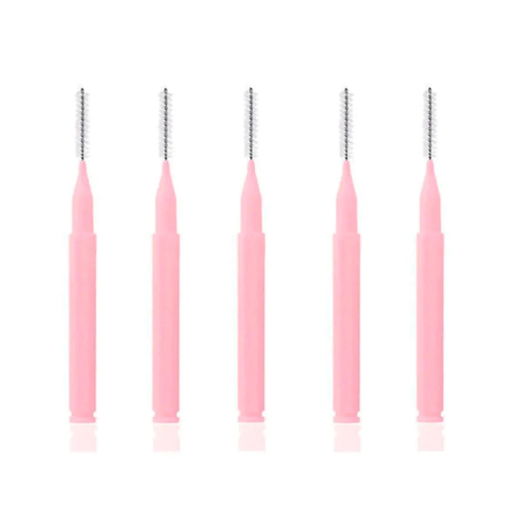 A row of five pink ultra-fine precision interdental-style brushes with 0.6mm tips and hexagonal handles, used for meticulous lash separation and brow lamination.