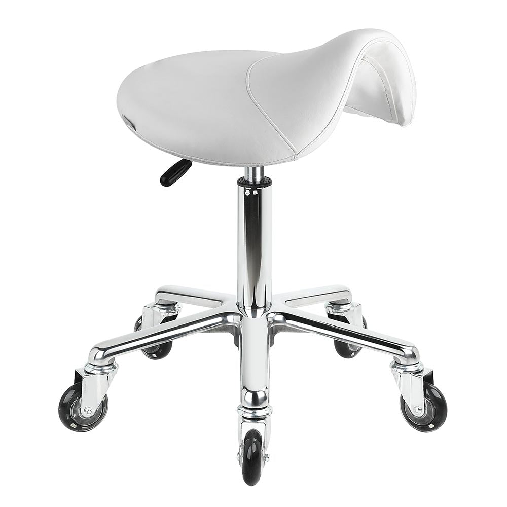 The Karma Evandale Saddle Stool features a contoured tan saddle seat, a polished aluminium base, and specialized hair-free rollerblade wheels.