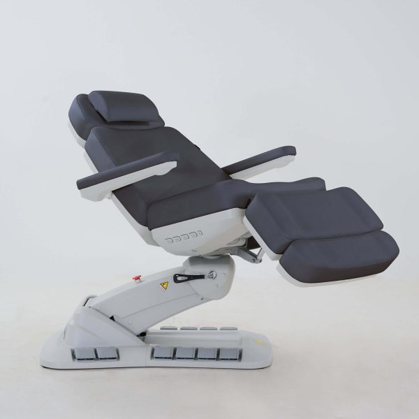 The Karma Queenstown Electric Beauty Bed  in charcoal and white, featuring a pedestal base with LED accents and side control panels for professional medical aesthetic treatments.