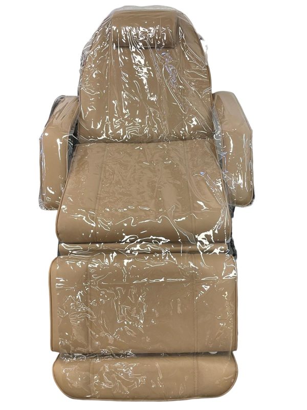 The Karma Universal Plastic Bed Cover  is a clear, 3-piece waterproof protector set fitted over a white electric treatment bed, showing headpiece, main body, and arm covers.