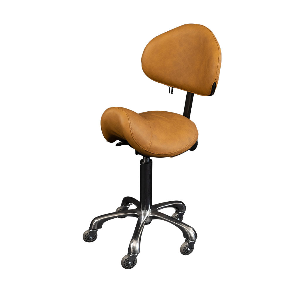 The Karma Cradle Mountain Saddle Stool features a tan ergonomic saddle seat, adjustable backrest, and a polished aluminium 5-star base with hair-free rollerblade wheels.