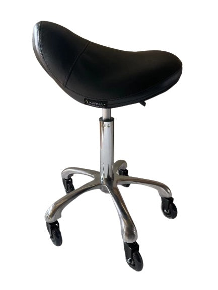 The Karma Evandale Saddle Stool features a contoured tan saddle seat, a polished aluminium base, and specialized hair-free rollerblade wheels.