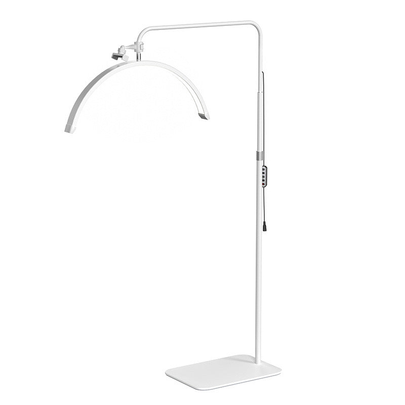 The Karma Half Moon Beauty Light  is a white 23-inch curved arc floor lamp featuring a low-profile flat base and an adjustable telescopic stand.