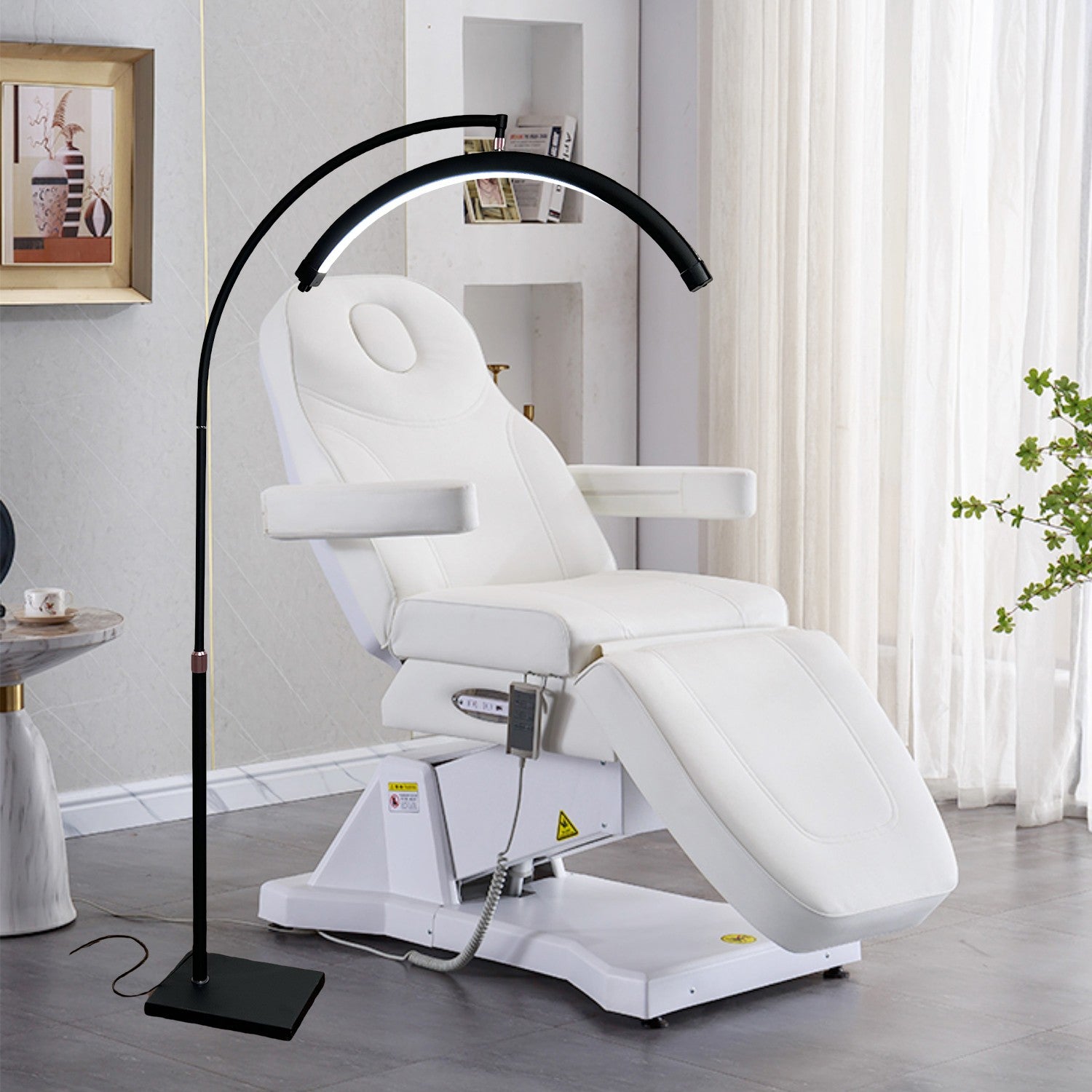 The Karma Half Moon Beauty Light is a black 28-inch wide curved arc treatment floor lamp featuring a low-profile flat base and internal hidden cable management.