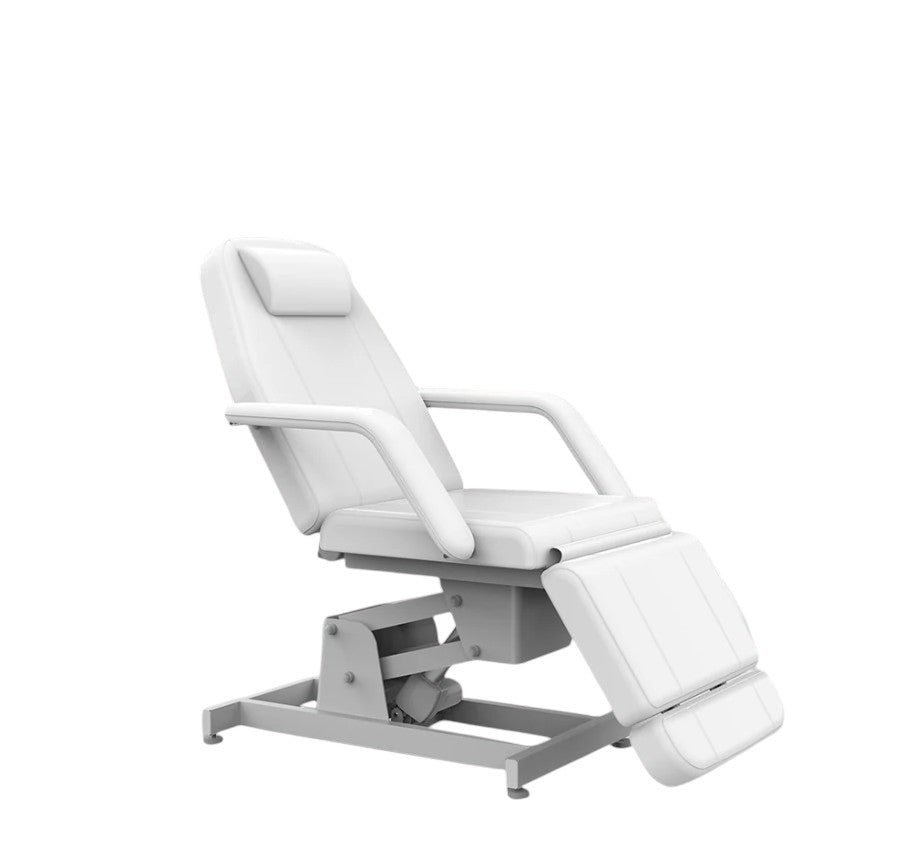 The Karma Hamilton V2  is a white part-electric beauty bed featuring a sturdy pedestal base, removable armrests, and an adjustable headrest with a face hole.