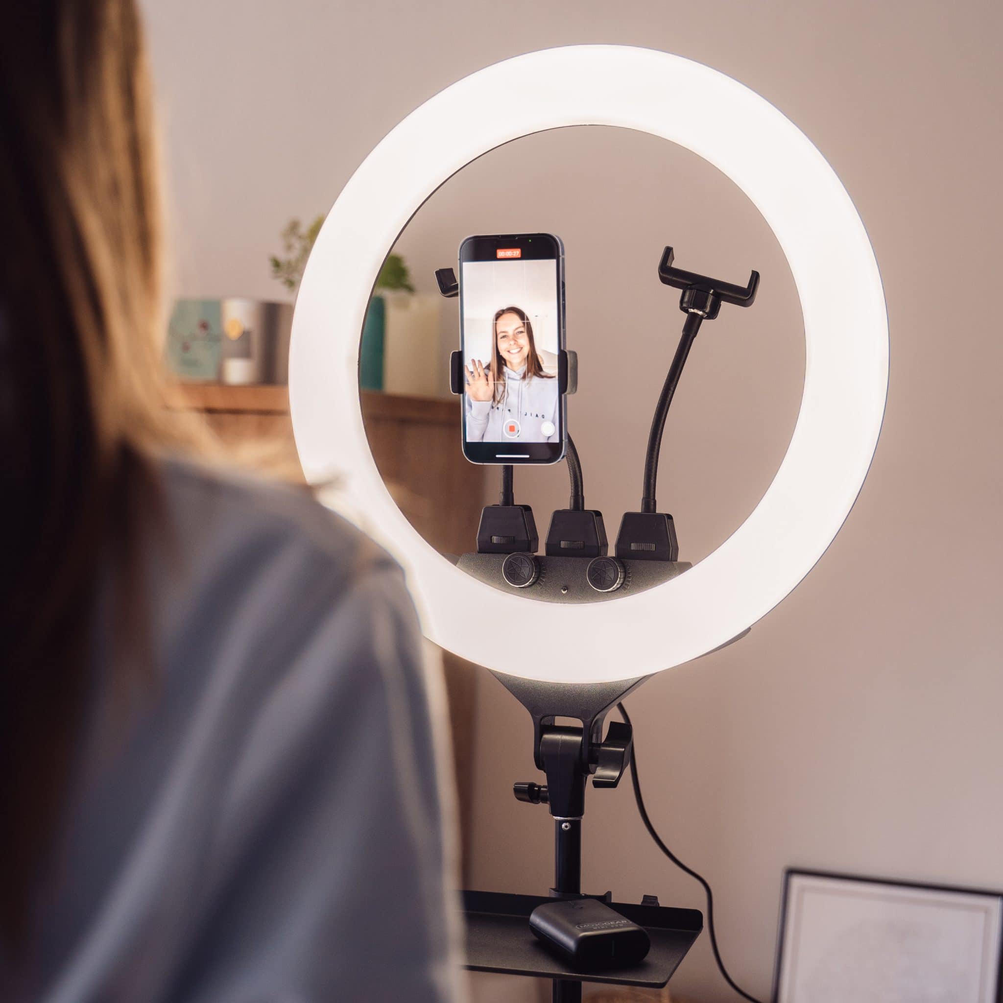 The Karma Ring Beauty Light is an 18-inch black LED ring light mounted on an adjustable floor tripod stand with a built-in central mirror interface.
