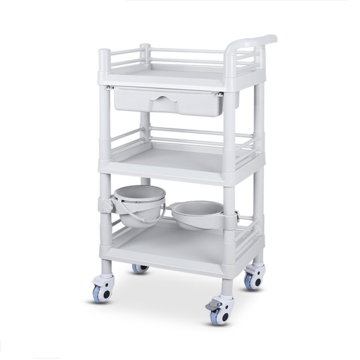 The Karma Wilton Small 3-Tier Beauty Trolley features a white ABS frame, a top-shelf security bar, a smooth-glide drawer, and medical-grade locking castors.