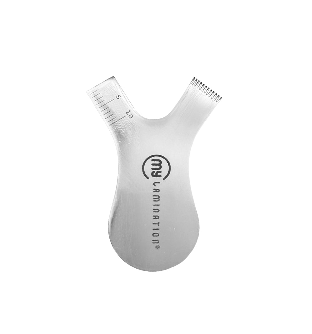 The My Lamination Lami Applicator PRO, a high-grade stainless steel Y-shaped tool with a precision comb on one side and a millimetre measurement scale on the other.